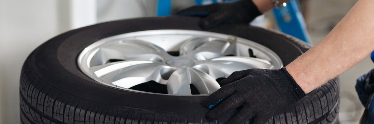 Mechanic selecting a tyre from stock - Tyres Sutton in Ashfield